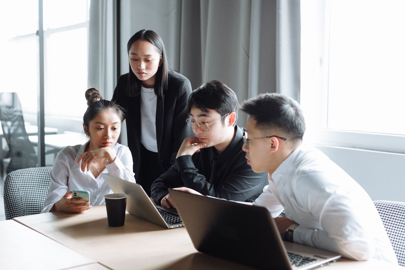 A business discussion around documents on a computer
